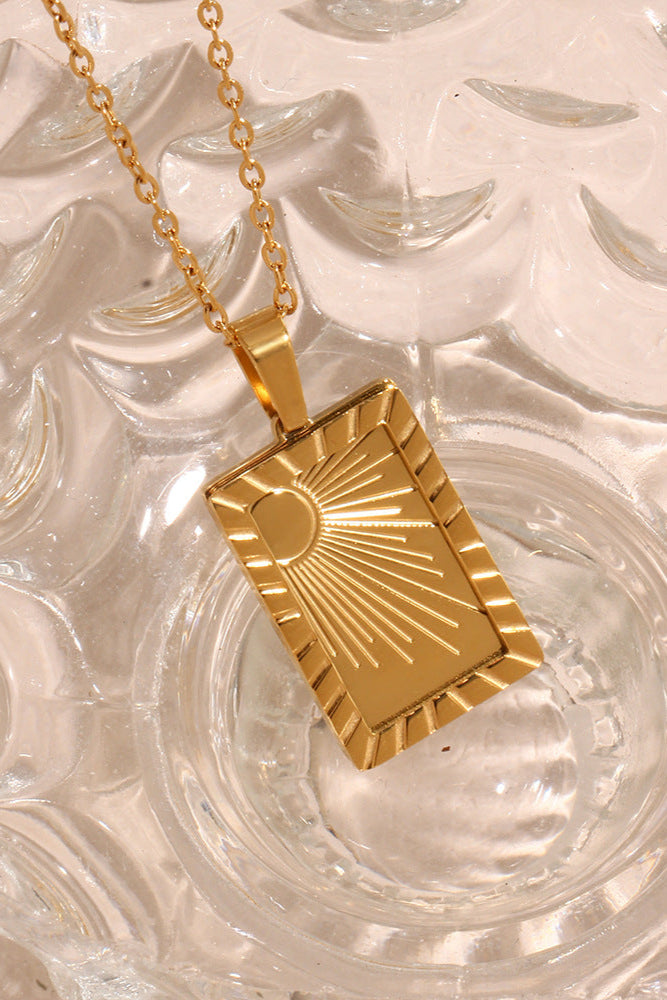Carved sun-shaped plaque necklace
