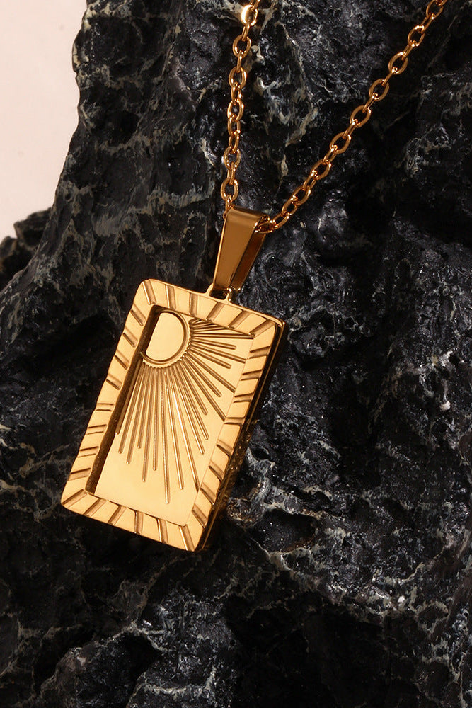 Carved sun-shaped plaque necklace