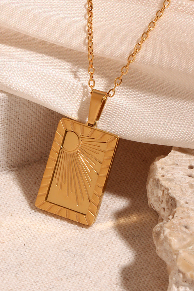 Carved sun-shaped plaque necklace