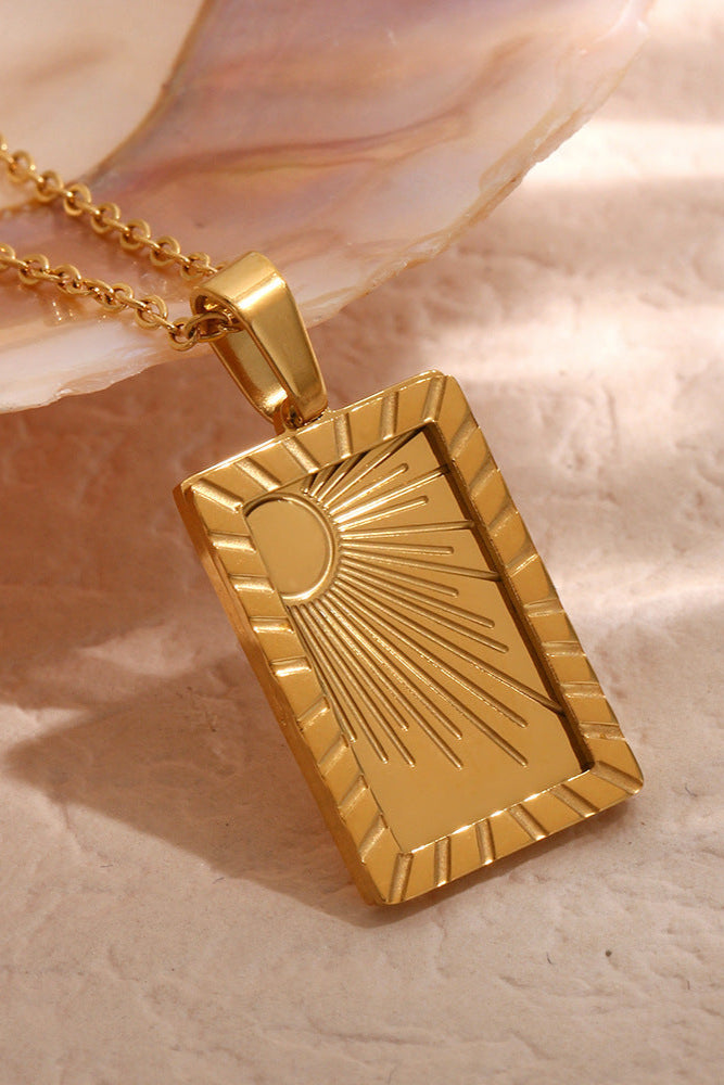 Carved sun-shaped plaque necklace