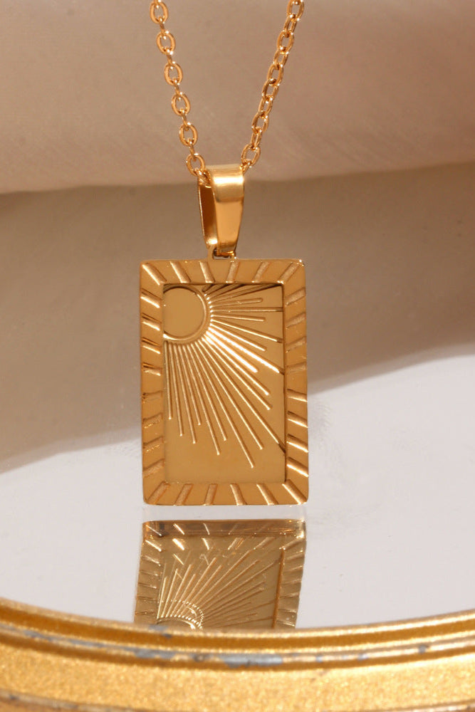 Carved sun-shaped plaque necklace